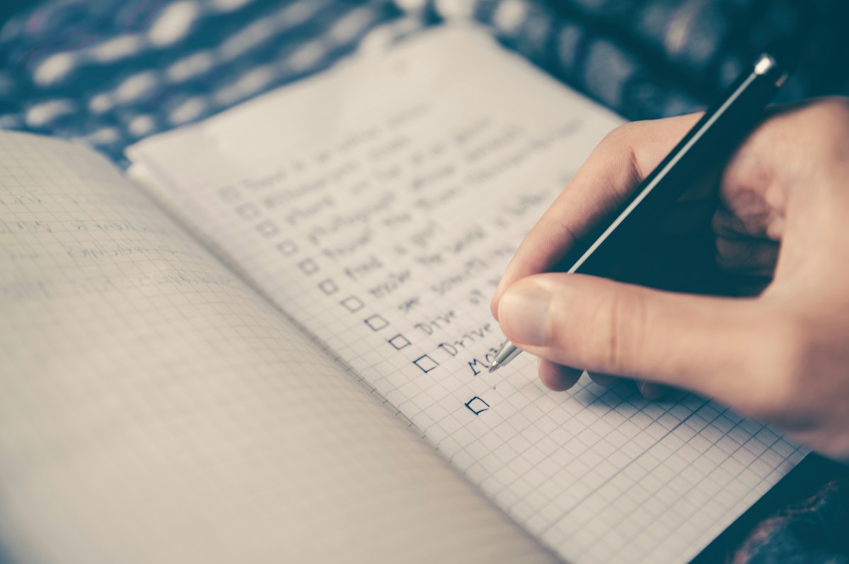 Notebook and pen on a desk used for weekly habit review